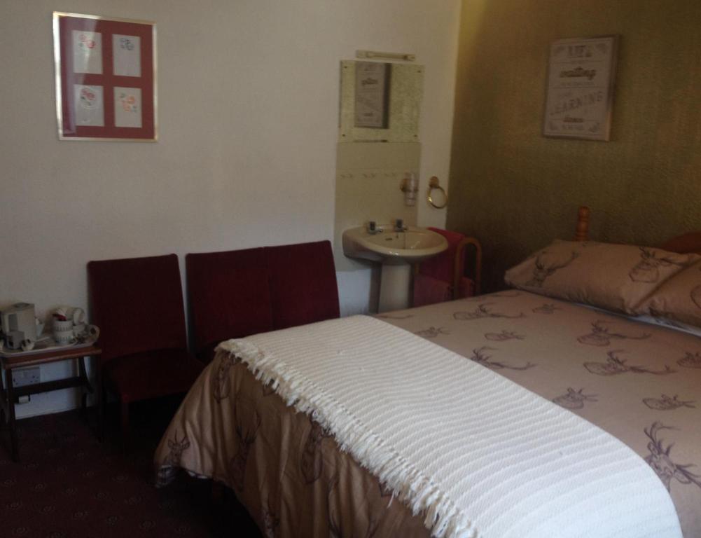 Postel nebo postele na pokoji v ubytování Tanglin Guest House