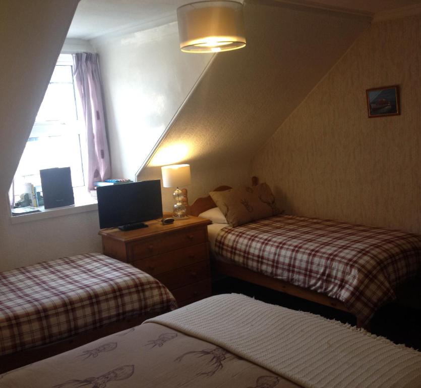 Postel nebo postele na pokoji v ubytování Tanglin Guest House