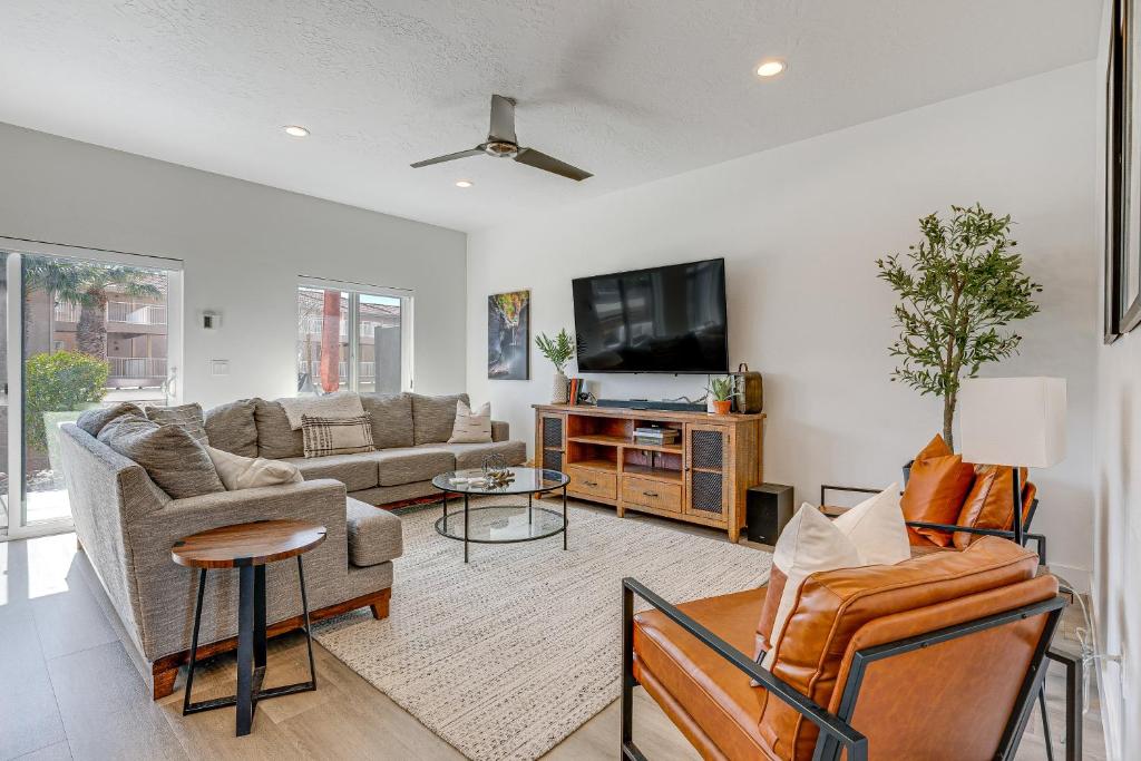 a living room with a couch and a tv at St George Home with Patio - 8 Mi to Snow Canyon! in St. George