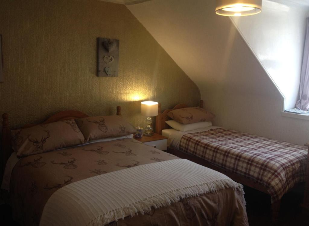 Postel nebo postele na pokoji v ubytování Tanglin Guest House