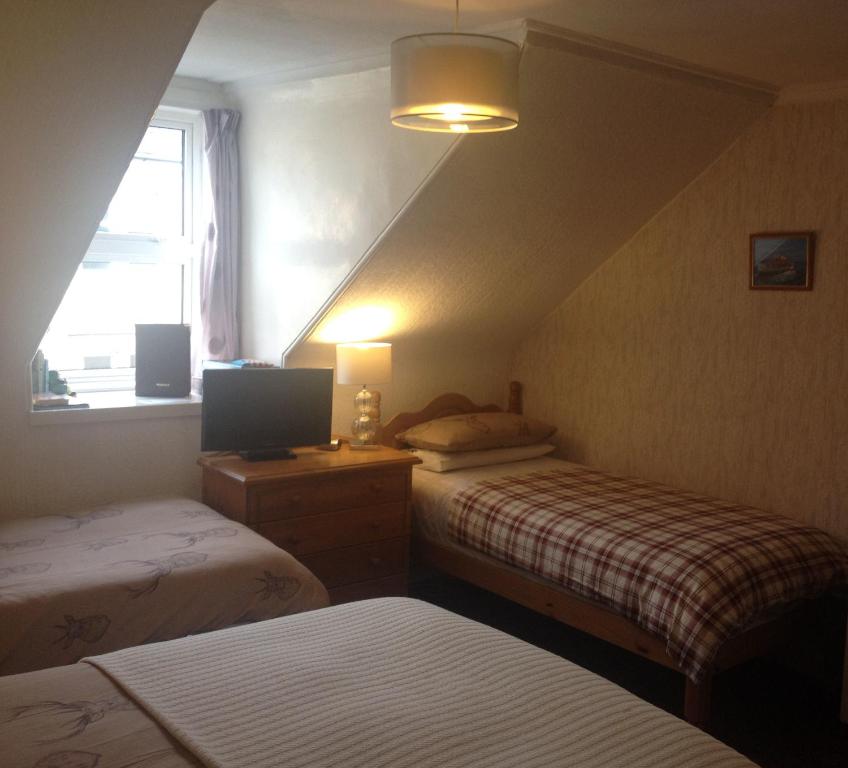 Postel nebo postele na pokoji v ubytování Tanglin Guest House