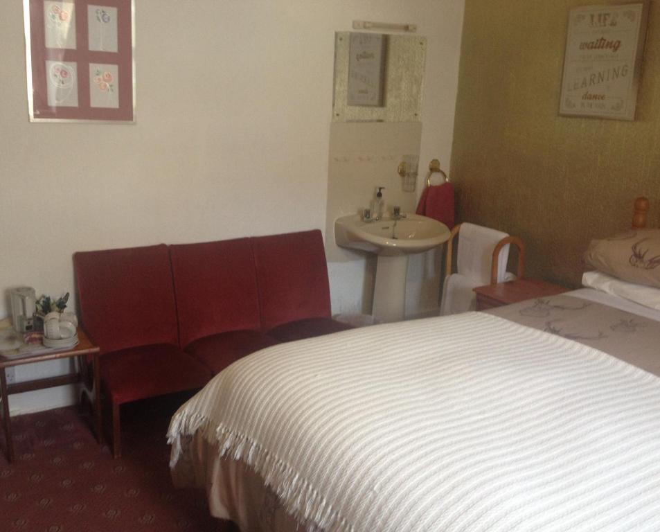 Postel nebo postele na pokoji v ubytování Tanglin Guest House