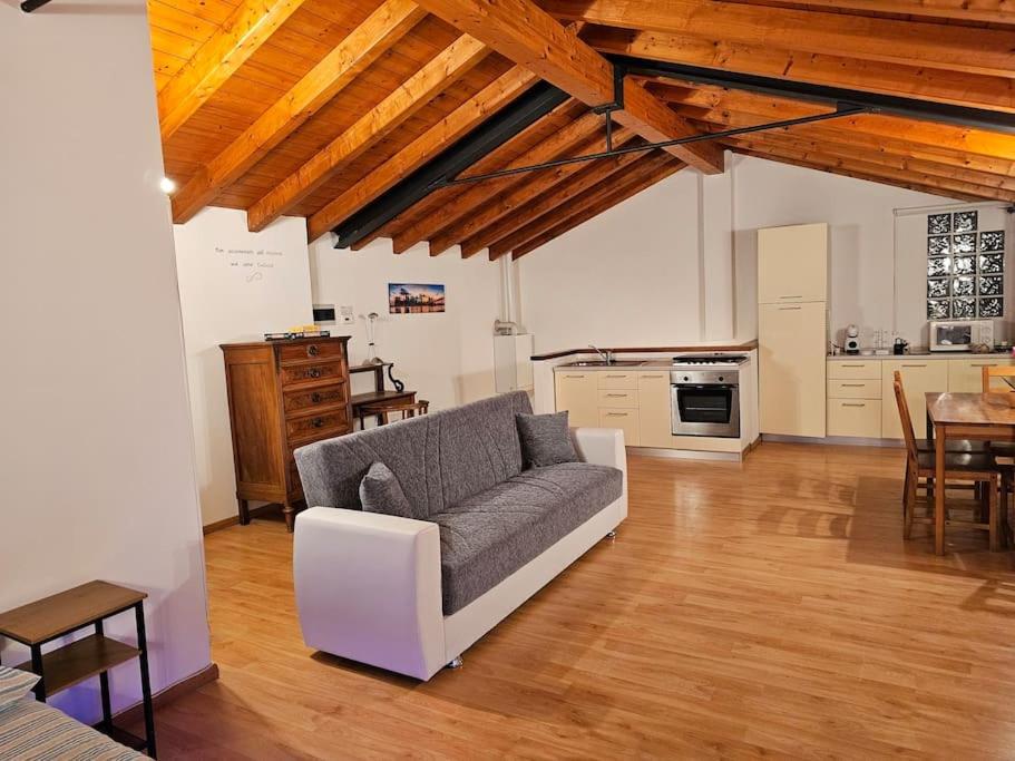 a living room with a couch and a kitchen at The view Lake ,Appartamento Blevio Fronte lago Como in Blevio