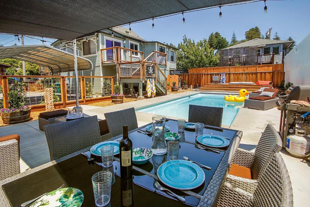 a dining table with a bottle of wine on a patio at Bed and Biscuit in Guerneville