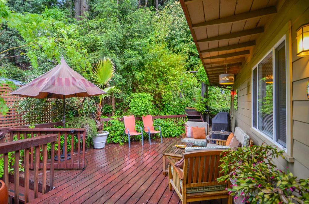 a deck with chairs and an umbrella on a house at Bonne Chere in Guerneville