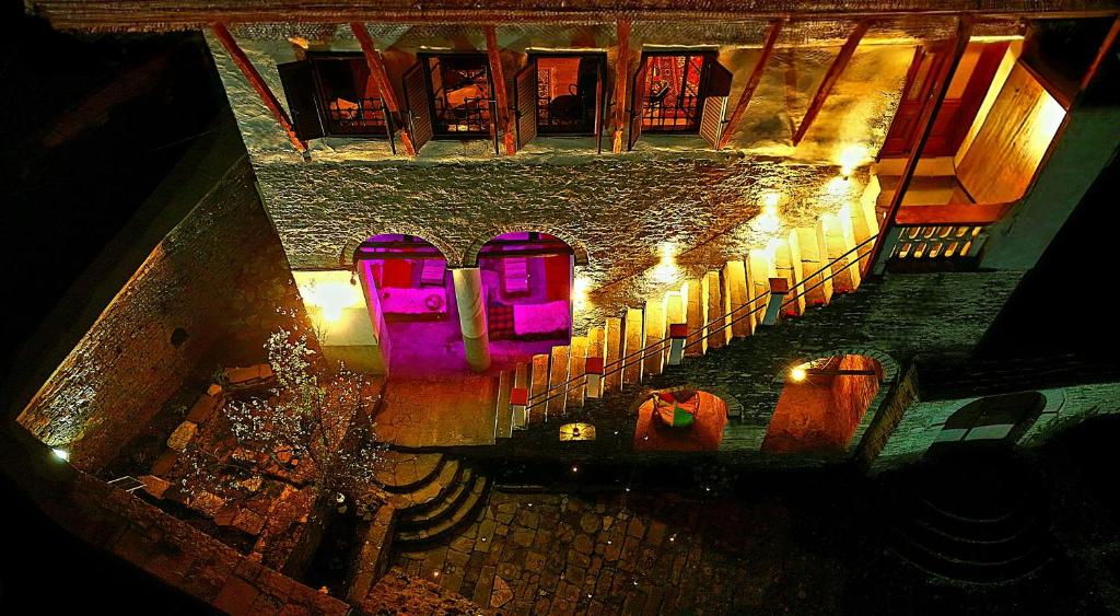 an overhead view of a building with purple lights at 1800's in Gjirokastër