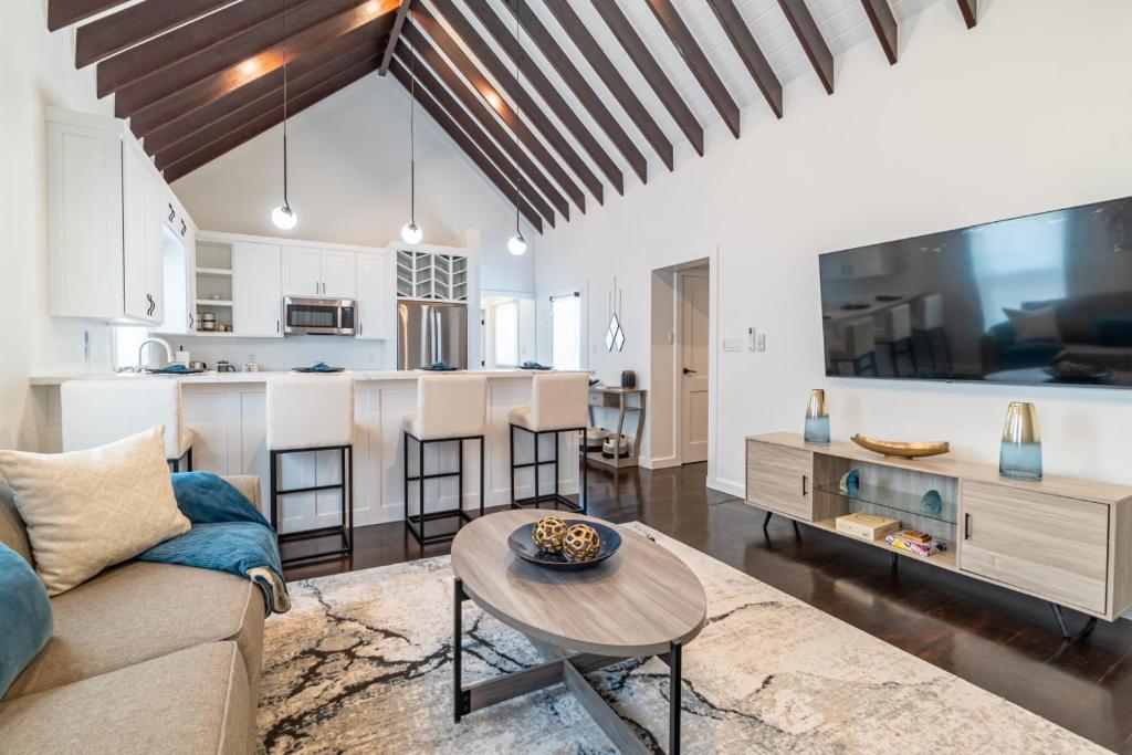 a living room with a couch and a table at Casa De Moya at Mahogany Bay & The PoolClub in San Pedro