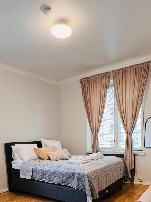 a bedroom with a large bed with a window at Your Chic Vibrant Airbnb in Helsinki