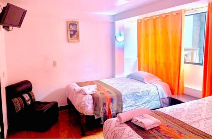 Postel nebo postele na pokoji v ubytování Tierra Mágica Hostal