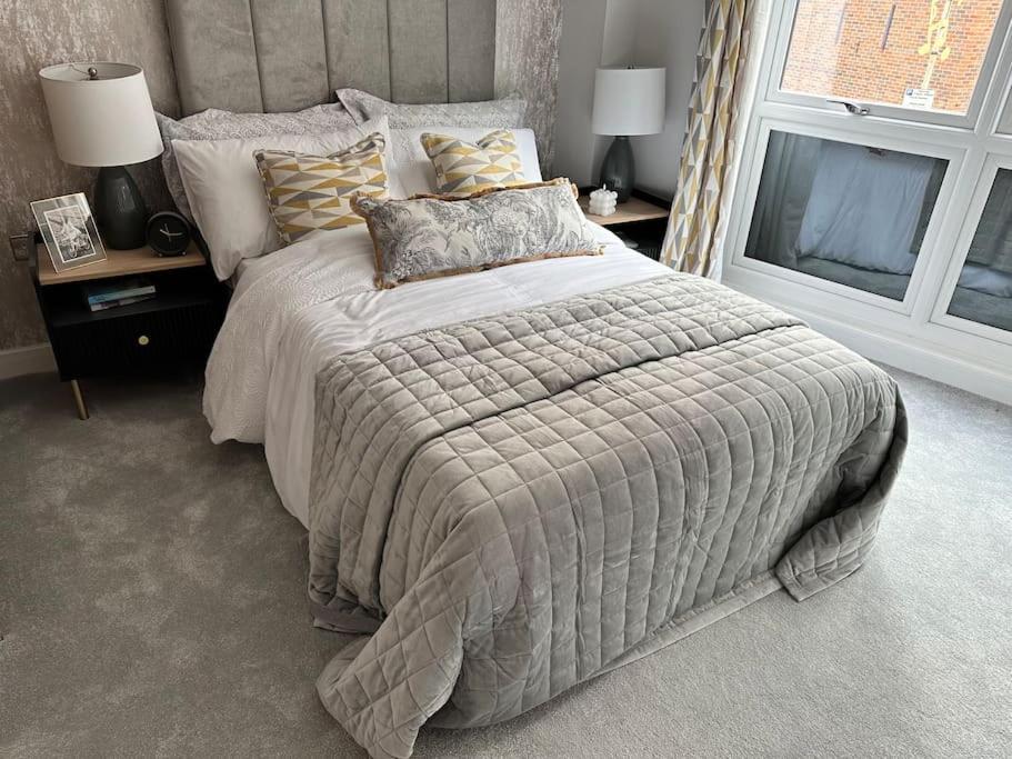a bedroom with a large bed and a window at Luxurious Flat at Leicester Town in Leicester