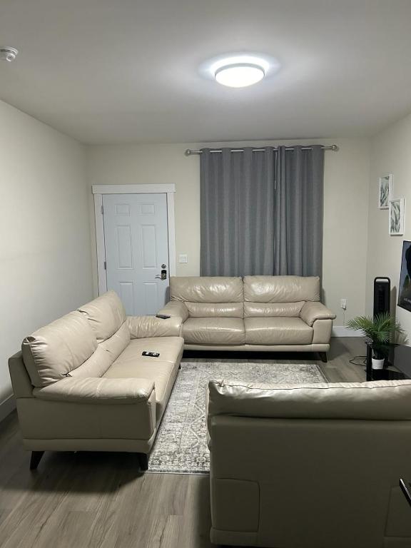 a living room with a leather couch and a table at Docker in Timberlea