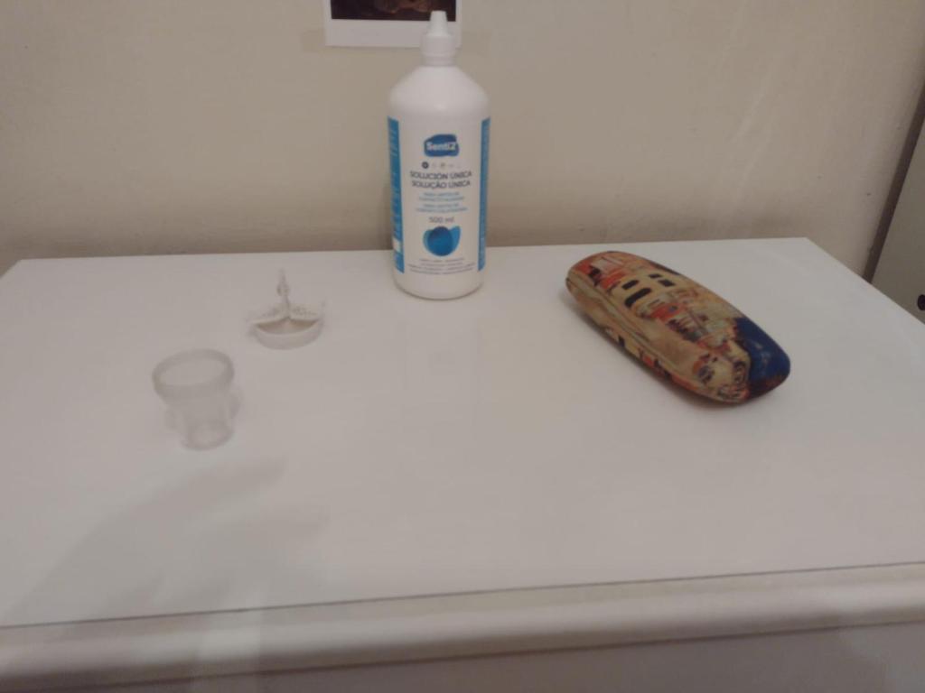eine Flasche Mundwasser und ein Spielzeug auf einem Waschbecken in der Unterkunft Habitación acogedora por días in Madrid