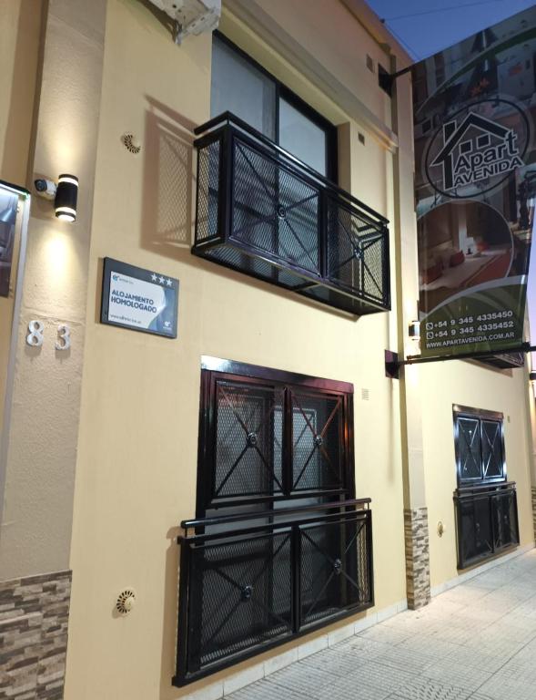 a building with black iron doors and windows at Apart Avenida in Concordia