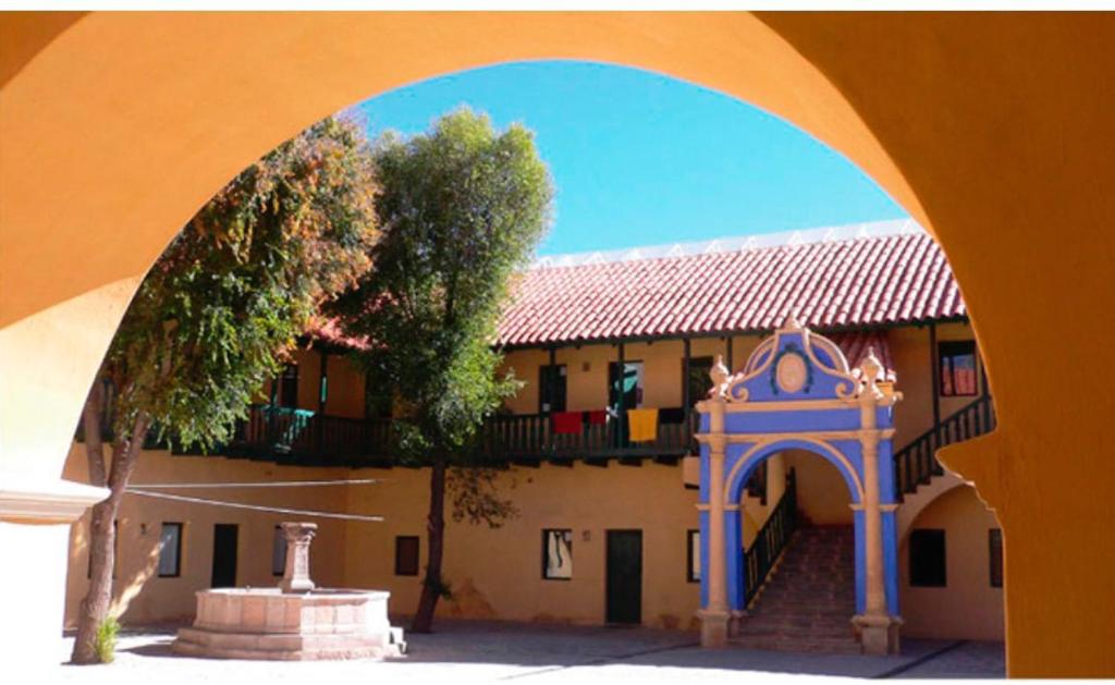 an archway in front of a building with a tree at Contando Historia in Potosí