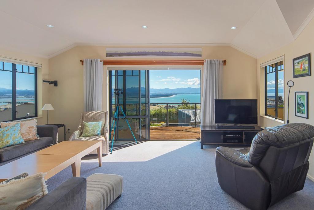 a living room with a view of the ocean at Jacaranda - Views over Tasman Bay in Nelson