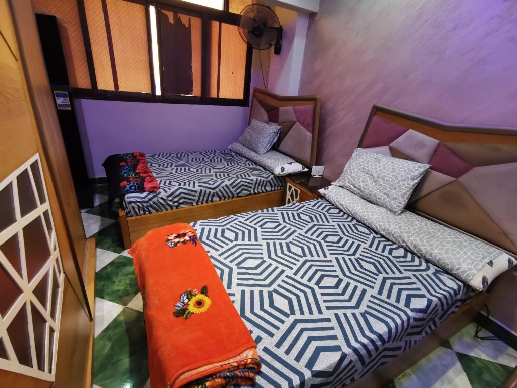 a small room with two beds and a couch at شقة فندقية في بورسعيد Hotel apartment in Port Said in Port Said