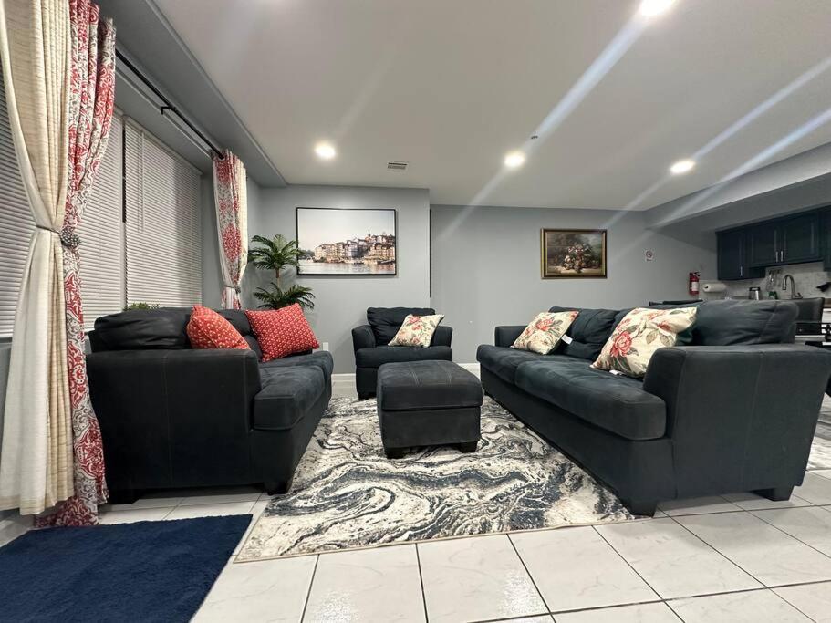 a living room with two couches at Luxury 2-Bedrooms 2-Bathrooms Near NYC/EWR in Newark