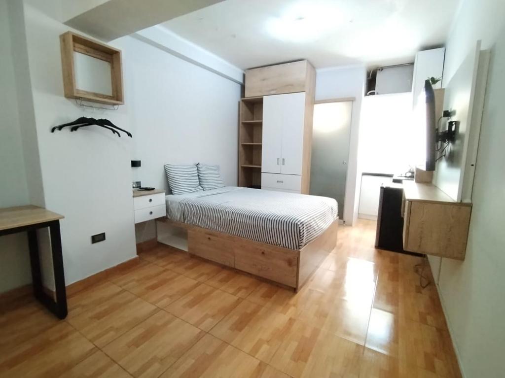 a bedroom with a bed and a wooden floor at Apartamento estándar en Lima Centro in Lima