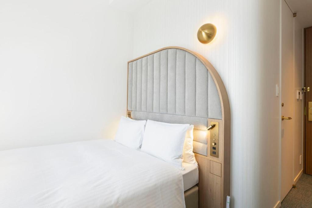 Postel nebo postele na pokoji v ubytování Hotel Comento Yokohama Kannai