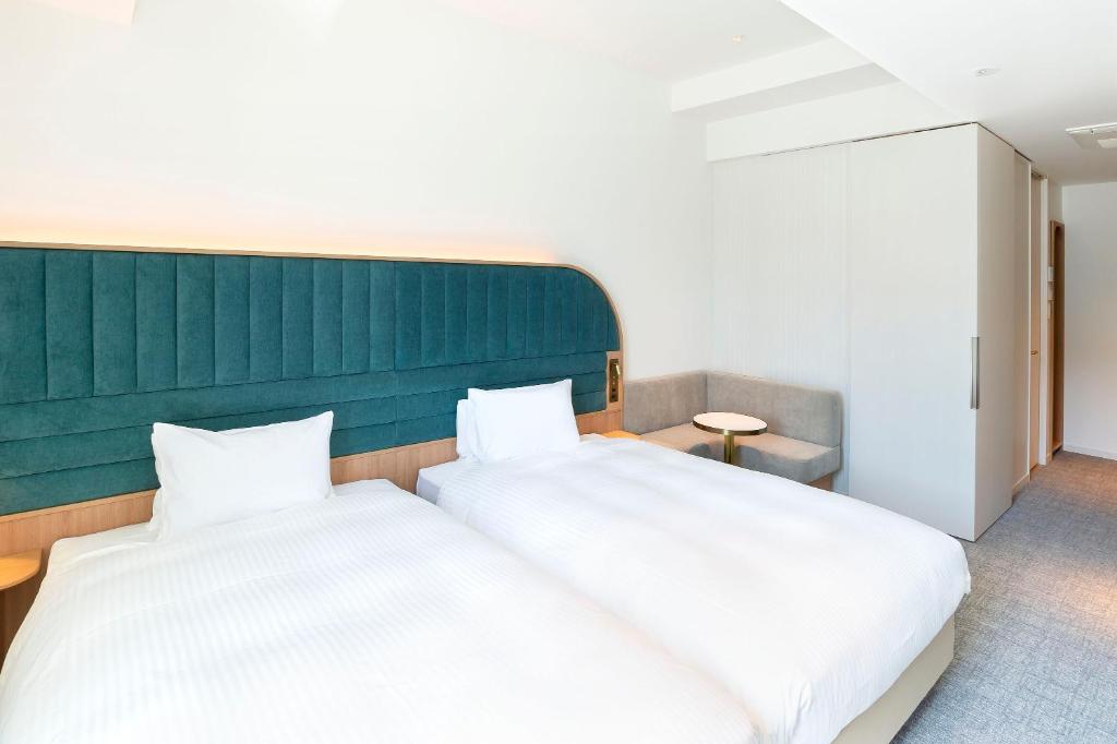 Postel nebo postele na pokoji v ubytování Hotel Comento Yokohama Kannai