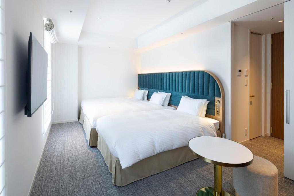 Postel nebo postele na pokoji v ubytování Hotel Comento Yokohama Kannai