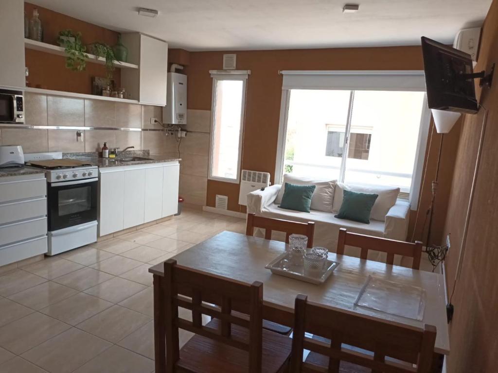 a kitchen with a table and a dining room at Bahia Blanca Estudio con Estacionamiento in Bahía Blanca