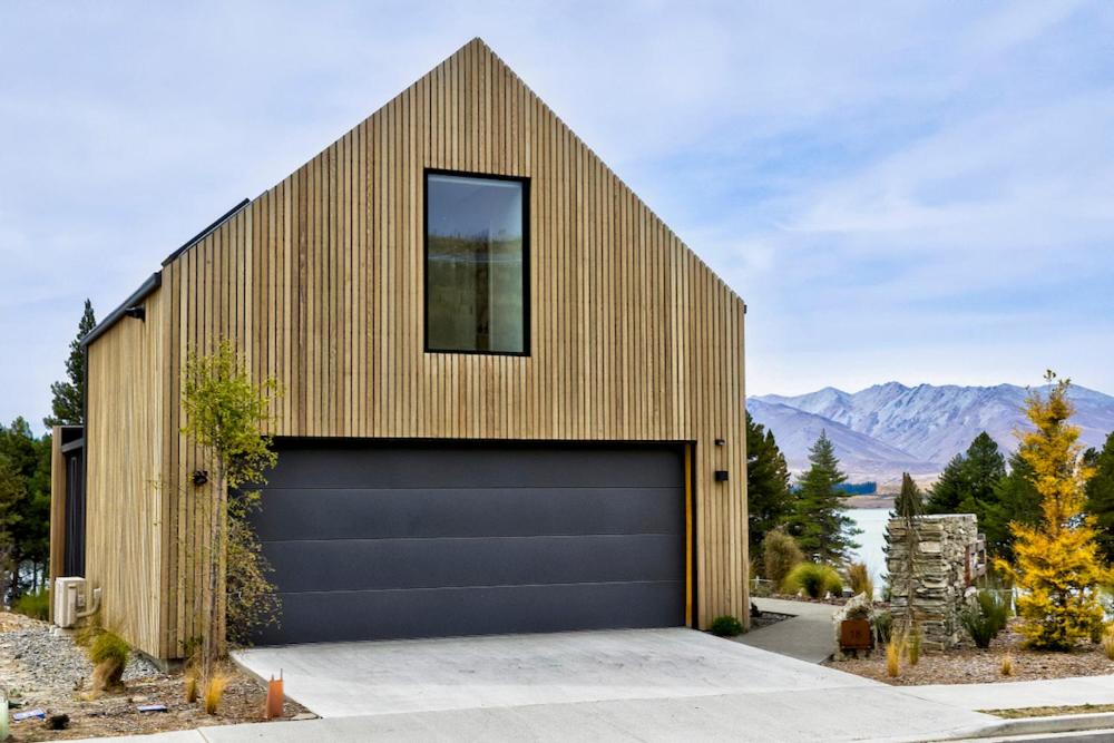 a building with a garage door and a window at Station Bay Lodges - The Retreat in Lake Tekapo