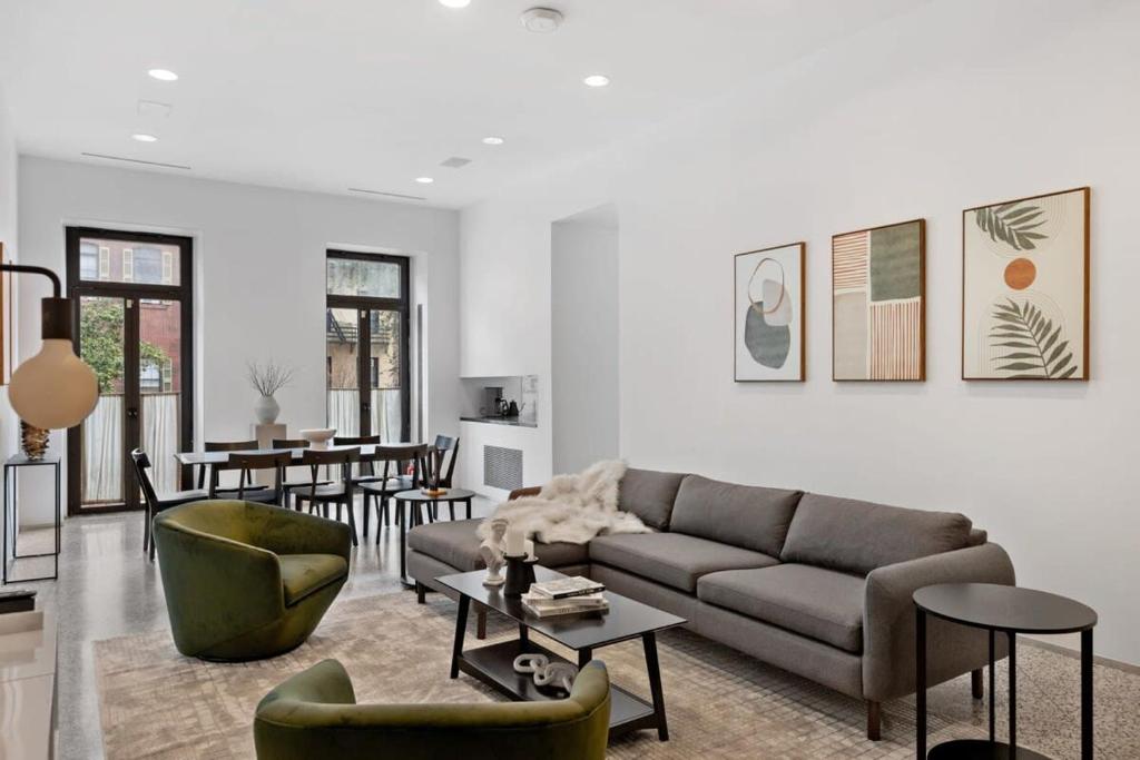 a living room with a couch and a table at Chelsea Canvas II by RoveTravel Large 3BR Duplex in New York