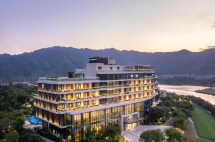 a large building with a view of a river and mountains at Wyndham Fuzhou Guian in Beijing