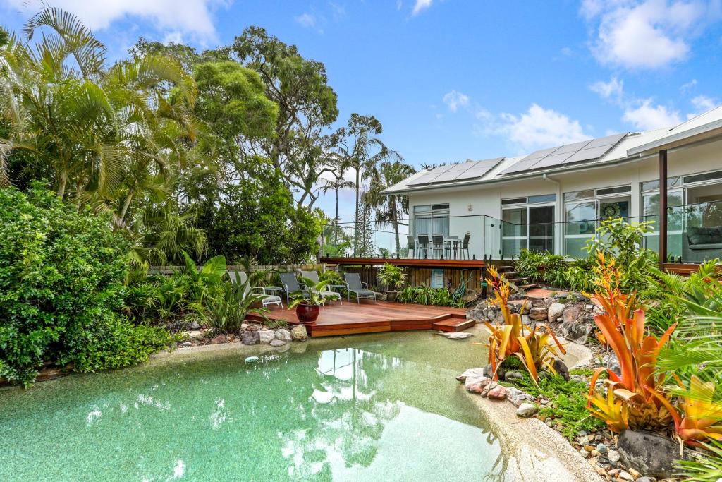 an exterior view of a house with a swimming pool at A Tropical Family Oasis in Sunshine Beach in Sunshine Beach