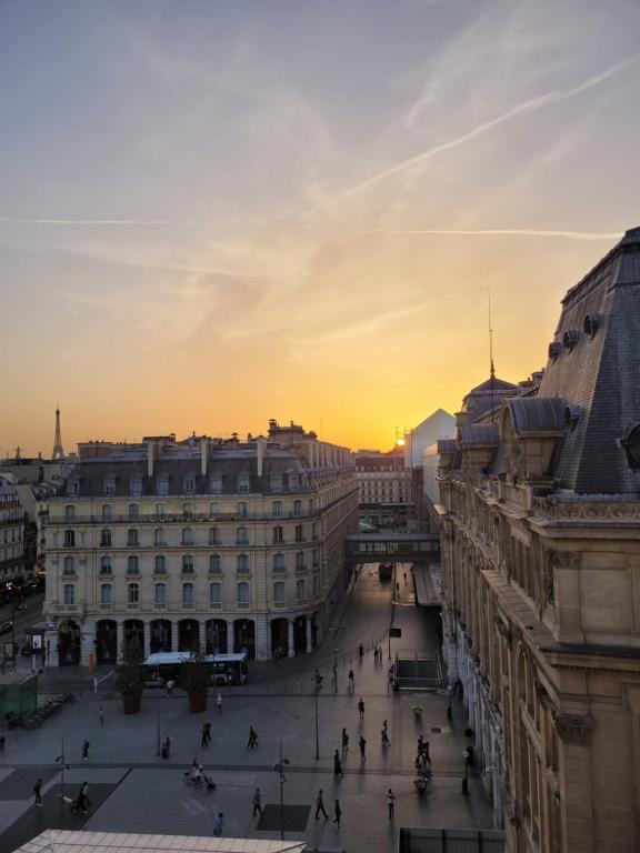 a view of a street in a city at sunset at En plein cœur de Paris Saint-Lazare Hausman / Paris center Hausman Opera in Paris