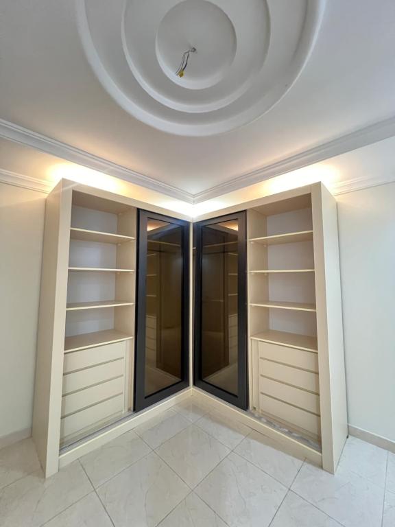 a walk in closet with a clock on the ceiling at جدة in Jeddah