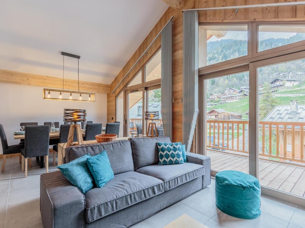 a living room with a couch and a large window at Appartement Champagny-en-Vanoise, 5 pièces, 10 personnes - FR-1-638-24 in Champagny-en-Vanoise