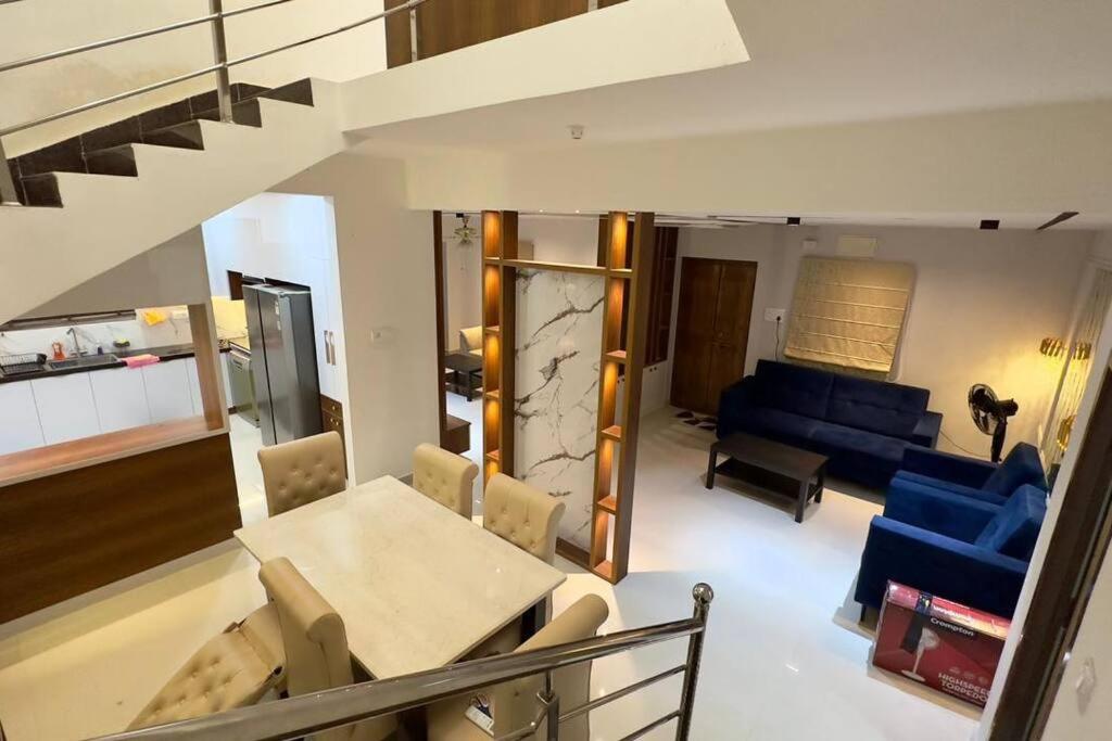 a living room with a table and a couch at Brand New Luxurious Independent Villa in Hyderabad