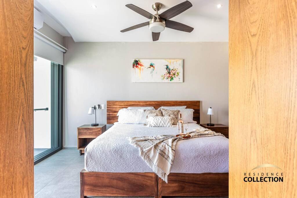 a bedroom with a bed with a ceiling fan at Nuevo Estudio en Aria Ocean 609 in Nuevo Vallarta