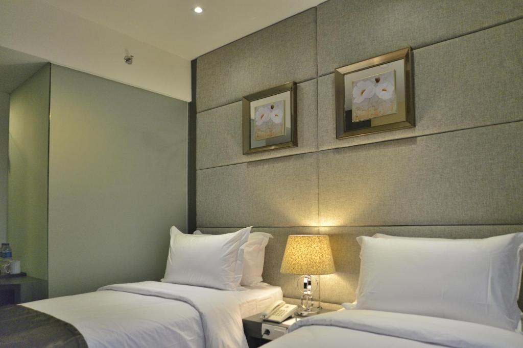 Postel nebo postele na pokoji v ubytování Serela Merdeka by KAGUM Hotels