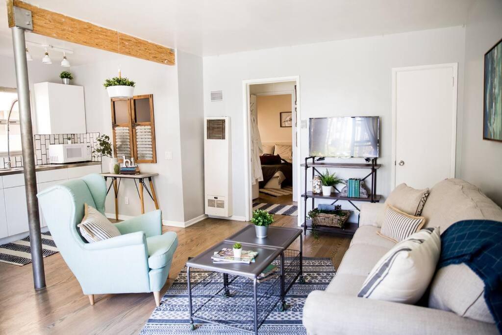 a living room with a couch and a table at Seaside Bliss -Downtown! Beach! ConvCenter! Bikes! in Long Beach