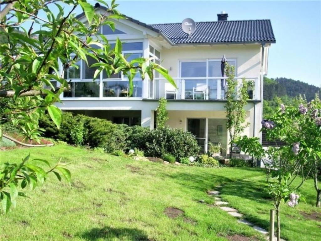 une grande maison blanche avec une cour verdoyante dans l'établissement Wohnung in Trubenhausen mit Grill, Terrasse und Garten, à Trubenhausen