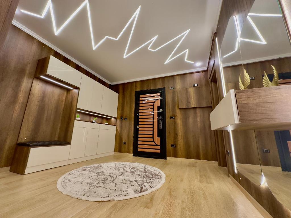 a living room with a staircase and a ceiling with lights at Degla view - Cairo in Cairo