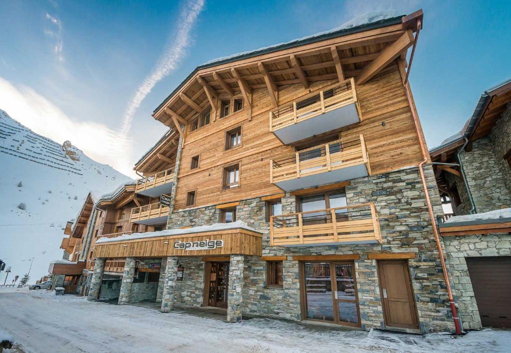 a large wooden building with a balcony on it at Residence Cap Neige in Tignes