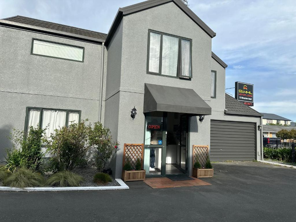 a house with an awning on the front of it at Samhil Motor Lodge in Christchurch