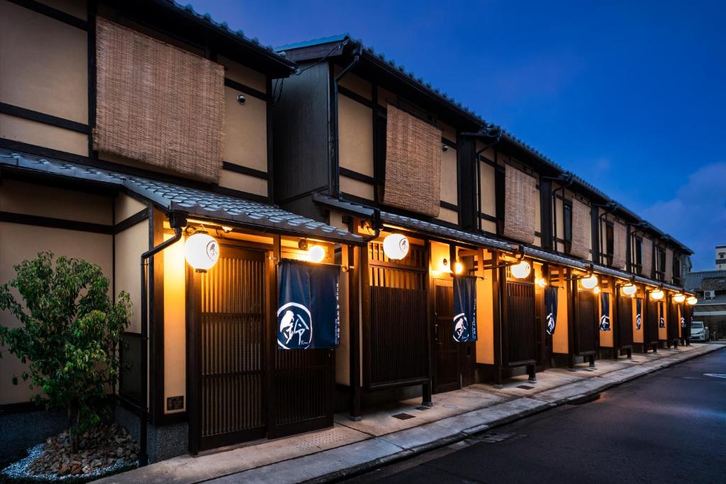 a row of buildings with lights on a street at Rinn Hanayacho Asagiri in Kyoto