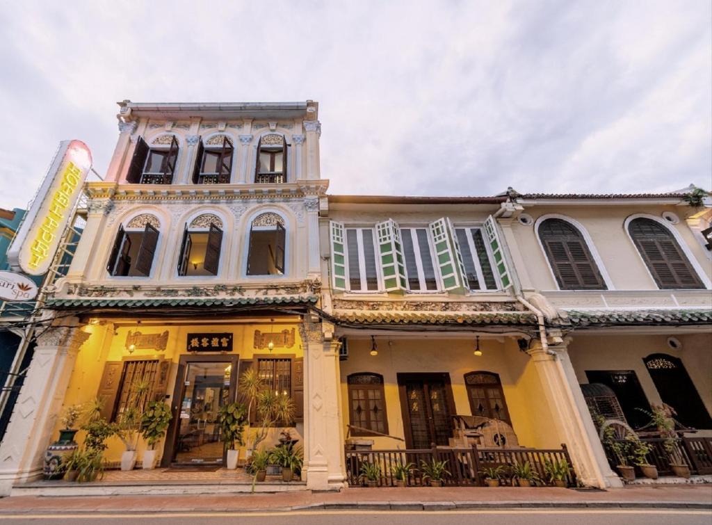 a large white building with windows on a street at Hotel Puri Melaka in Malacca