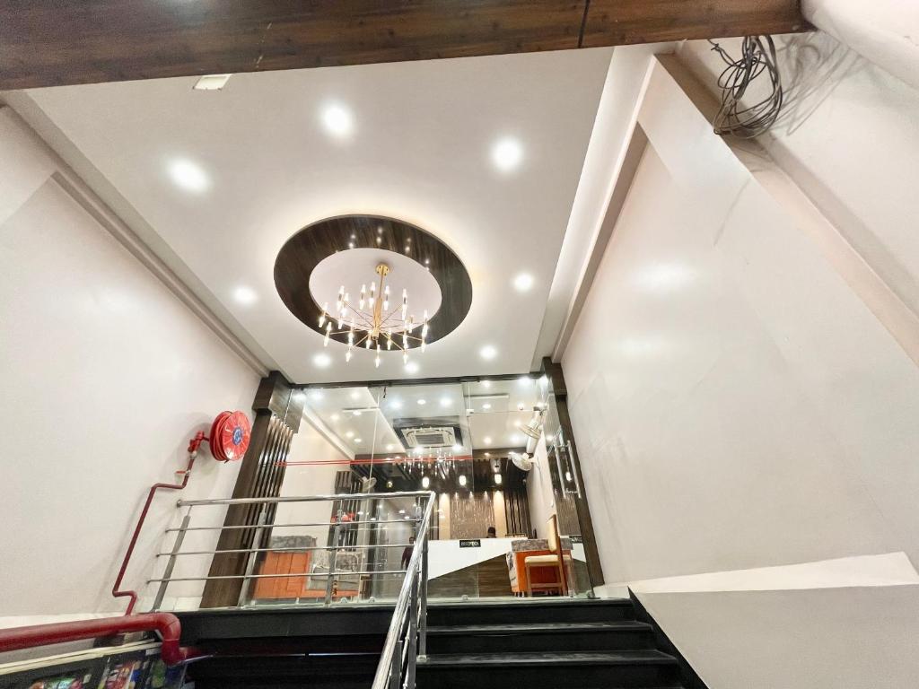 a staircase in a building with a chandelier at XYZ hotle in Puri