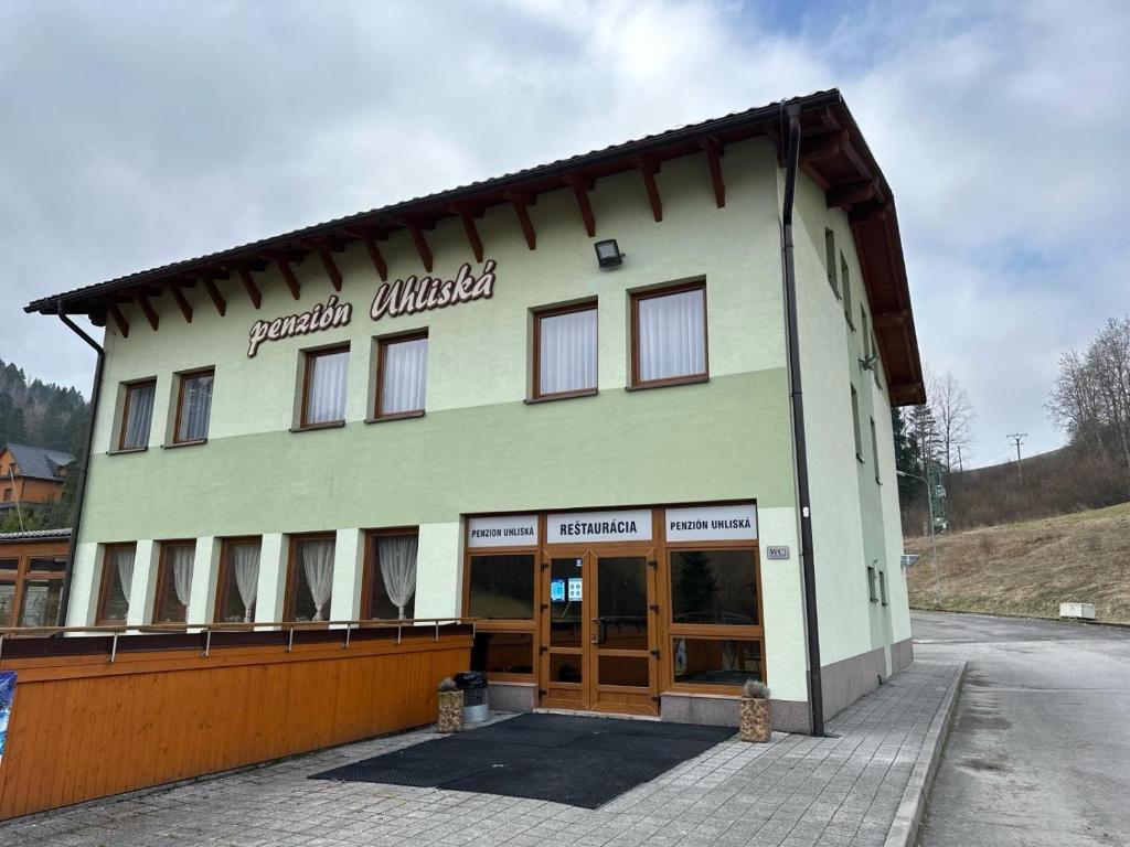 a building with the words north united on it at Penzión Uhliská in Nižná