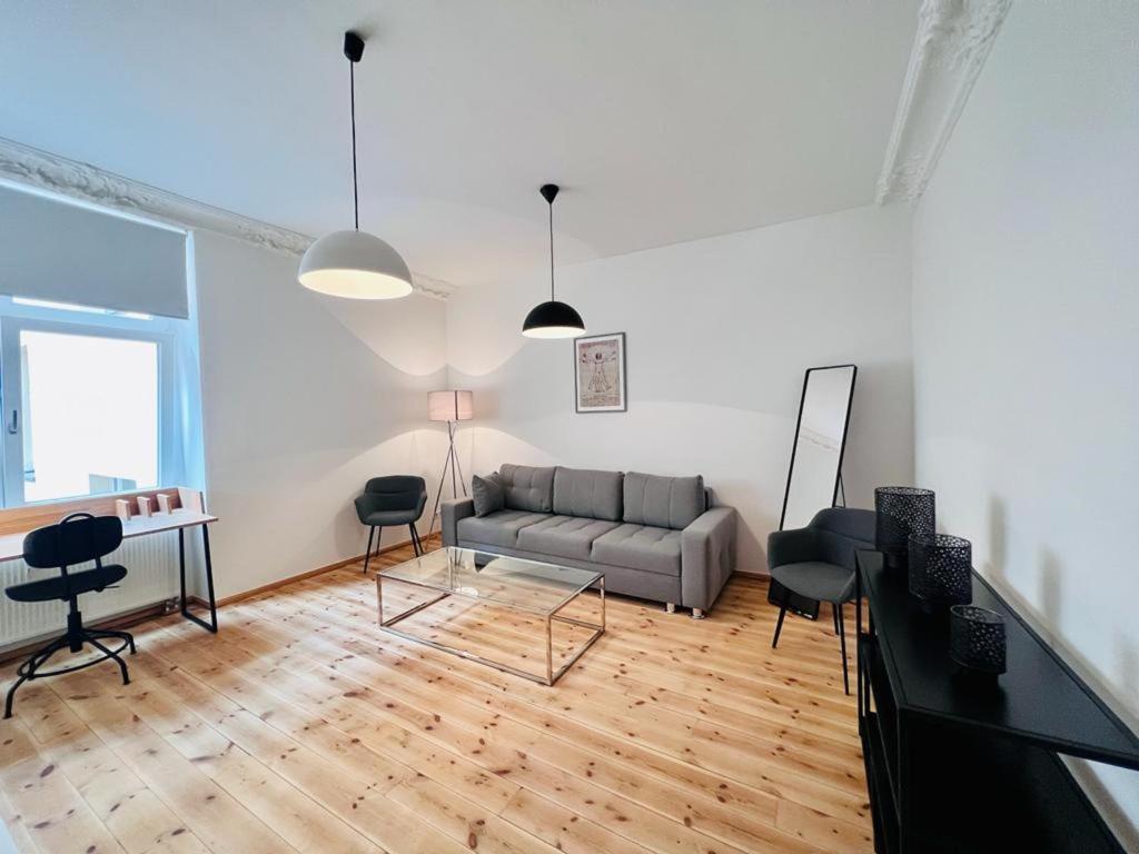 a living room with a couch and a table and chairs at Central City Cosy Lux in Berlin
