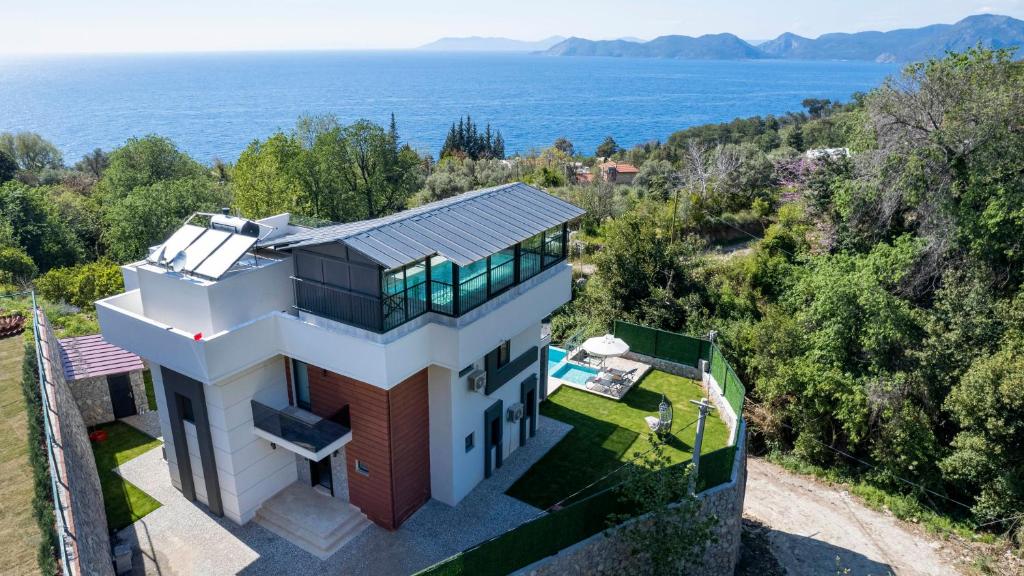 an aerial view of a house with a view of the ocean at Villa Mariposa in Fethiye