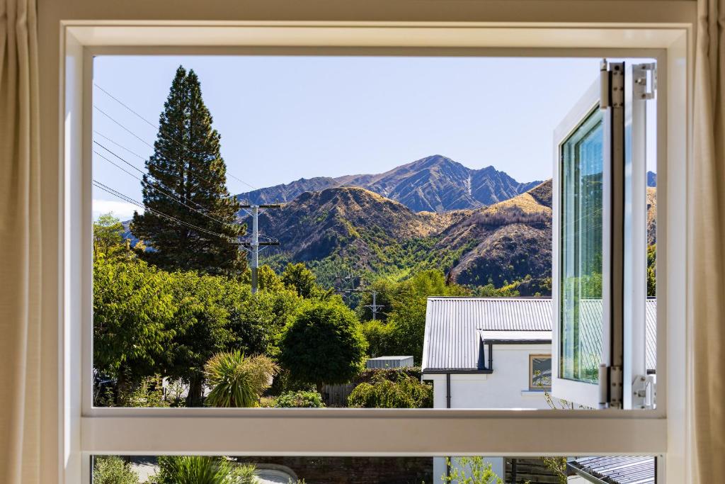 a window with a view of mountains at The Apartment at Arrowtown in Arrowtown