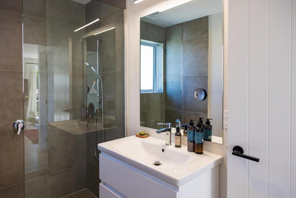 a bathroom with a sink and a shower at The Apartment at Arrowtown in Arrowtown