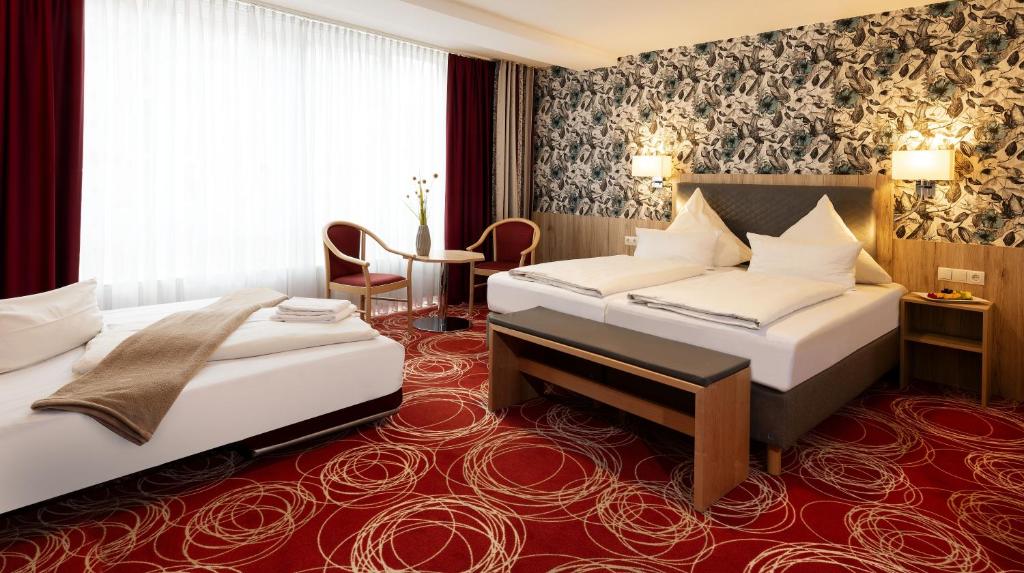 Postel nebo postele na pokoji v ubytování Hotel Löwengarten